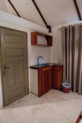 a kitchen with a sink next to a door at Oasis beach resort in Cape Coast