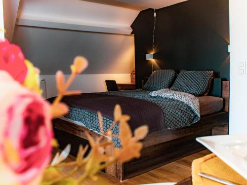 a bedroom with a bed and a couch at Au Vent des Blés in Incourt