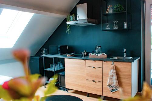 a kitchen with a sink and a counter top at Au Vent des Blés in Incourt