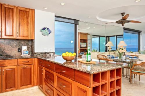 a kitchen with a large island with a counter top at Mahana by KBM Resorts in Kaanapali