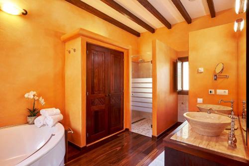 a bathroom with a large tub and a sink at Exclusive 4 Bedroom Villa in Mahon 1281 in Sant Carles de Peralta