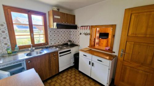 a small kitchen with a sink and a window at Chalet Chapon Joly 8 personnes in Evolène