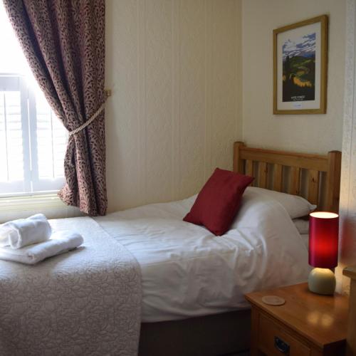 a hotel room with two beds and a window at Bewdley Hill House in Kidderminster