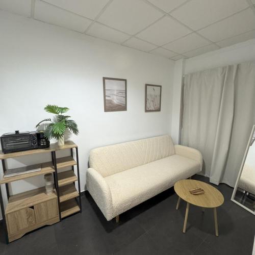 a living room with a couch and a table at Med Time Hotel Boutique in Calpe