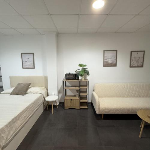 a bedroom with two beds and a couch at Med Time Hotel Boutique in Calpe