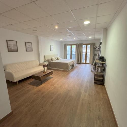 a large living room with a bed and a couch at Med Time Hotel Boutique in Calpe