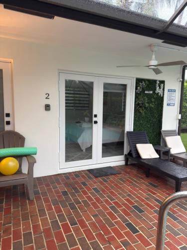 a patio with two benches on a brick patio at Sunset Shores in Lake Clarke Shores