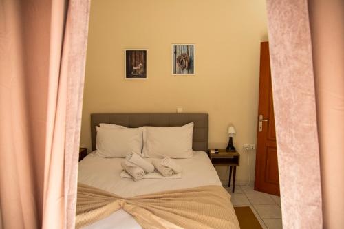 a bedroom with a bed with two pillows on it at Gk Suites-Constantin view , auto check-in 24h in Larisa