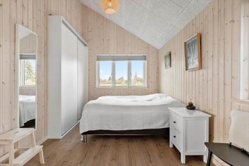 a bedroom with a white bed and two windows at M232-Stubbekobing-Pilehegnet-21 in Stubbekøbing