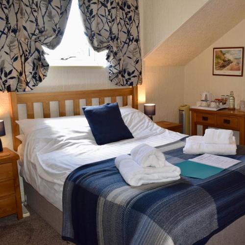 a bedroom with a bed with towels on it at Bewdley Hill House in Kidderminster