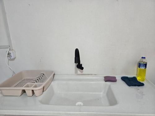a kitchen counter with a sink and a phone at Residencial Lima - Quarto 03 in São Luís