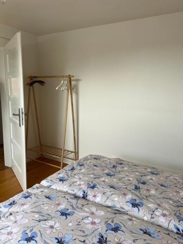 a bedroom with a bed with a floral bedspread at Elegantes Apartment in Villa in Ottobeuren