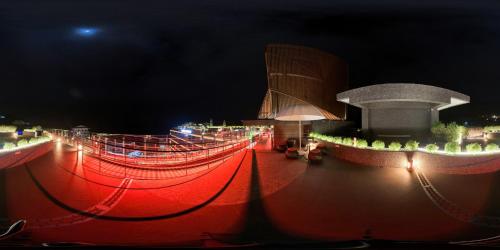 a red lighted walkway with a building at night at Hotel Indigo Alishan by IHG in Fanlu