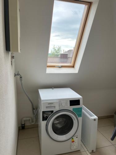 a washing machine in a room with a window at Elegantes Apartment in Villa in Ottobeuren