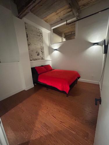 a bedroom with a red bed in a room at The hancock loft in Philadelphia