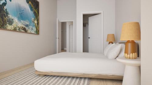 a white bedroom with a bed and a lamp at Flow Brickell Hotel in Miami