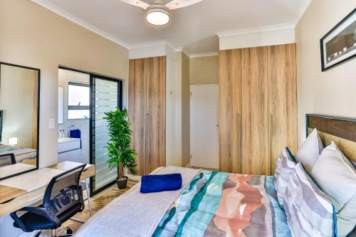 a bedroom with a bed and a desk in it at 169 Ballito Hills in Ballito