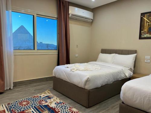 a hotel room with a bed and a window at Pyramids Motel in Cairo