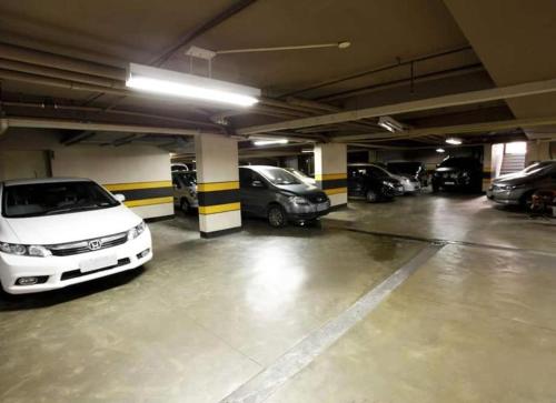 a parking garage with several cars parked in it at Elegance Praia Hotel in Rio de Janeiro