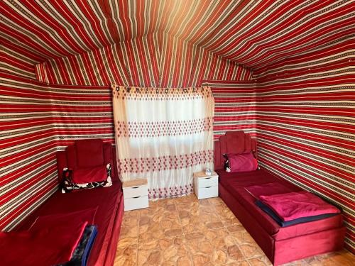 a room with two beds and a striped ceiling at Dana Sunset Eco Camp in Dana