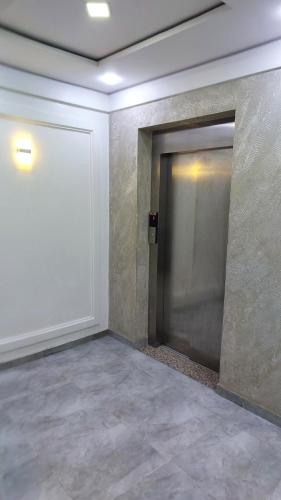 an empty hallway with a door in a building at Hotel BLADOR in Tichi