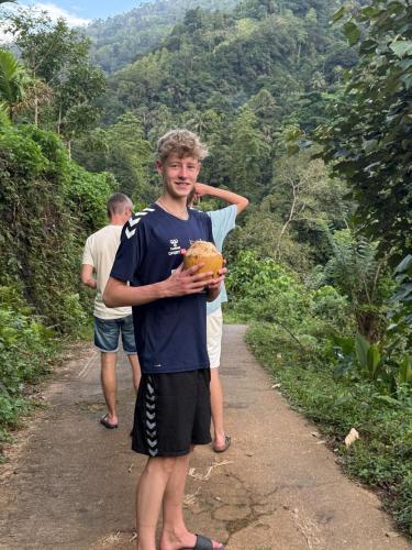 two young men standing on a dirt road at The Cave in Yatiyantota