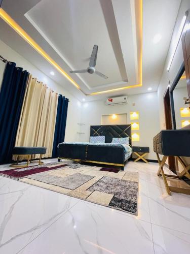 a living room with a couch and a bed at Cozy & comfy House in Rawalpindi