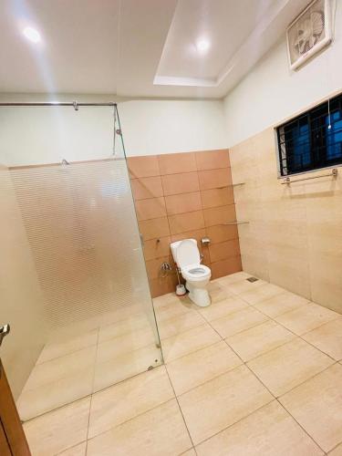 a bathroom with a shower and a toilet at Cozy & comfy House in Rawalpindi