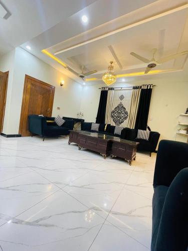 a large room with couches and tables in it at Cozy & comfy House in Rawalpindi