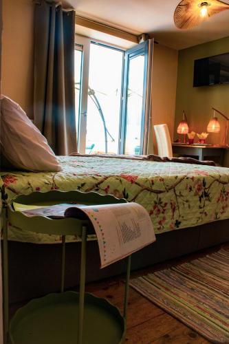 a bedroom with a bed with a book on it at Chambre Henriette in Incourt