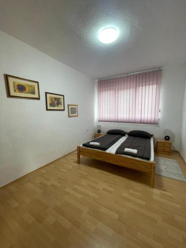 a bedroom with a bed in a room at Apartman Kulenović in Kulen Vakuf