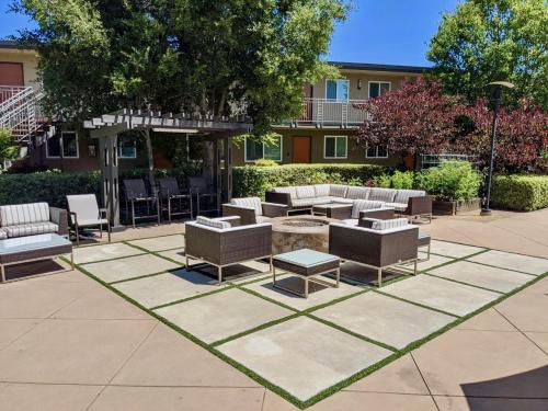 a patio with couches and tables in a courtyard at Downtown-King Bed-Top Floor-Parking-Wi-Fi in Walnut Creek