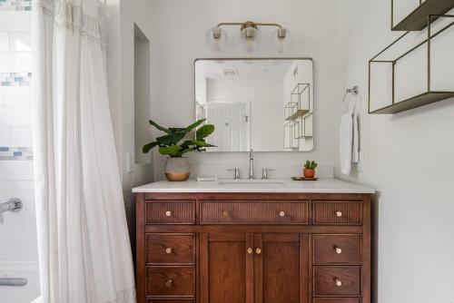 a bathroom with a sink and a mirror at Backyard Oasis w/Pool, Hot-Tub, Grill & Fire Pit! in Fredericksburg