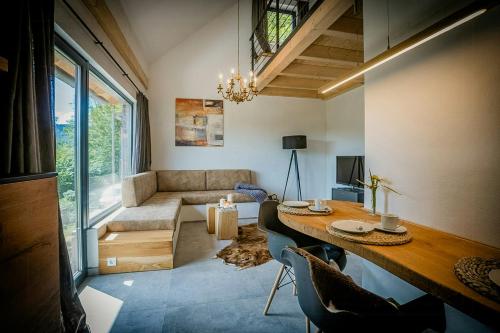 a living room with a table and chairs and a couch at Modern Chalet With Sauna Near Thuringian Forest in Zella-Mehlis