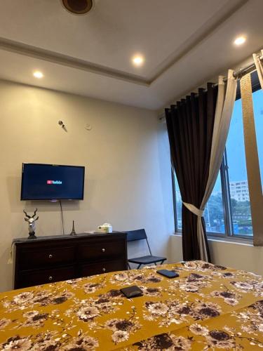 a bedroom with a bed and a flat screen tv at Luxury Eiffel View Gaming & Comfort in Lahore