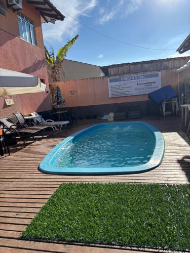 a large swimming pool sitting next to a building at Pousada Fênix,com piscina -250 METROS DA PRAIA in Pontal do Paraná