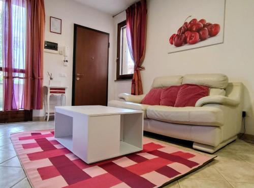 a living room with a couch and a table at Cherry House in Ponsacco