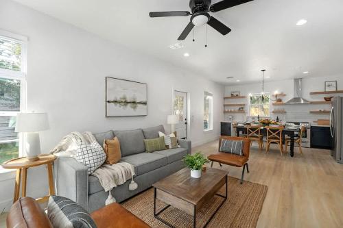 ein Wohnzimmer mit einer grauen Couch und einem Tisch in der Unterkunft The Malbec! in Fredericksburg