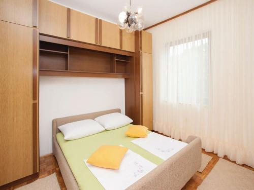 a bedroom with a bed with two pillows on it at Apartments Vesna in Pinezici
