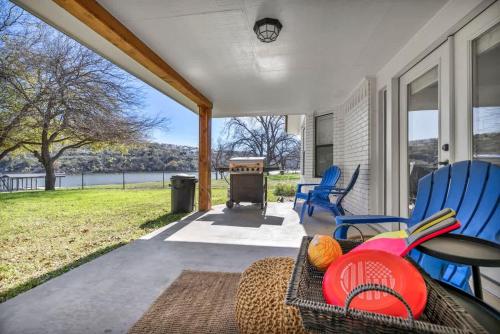 a porch with chairs and a table and a grill at Lakefront Paradise with Firepit in Meadowlakes