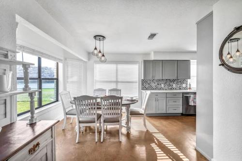 a kitchen and dining room with a table and chairs at Lakefront Paradise with Firepit in Meadowlakes