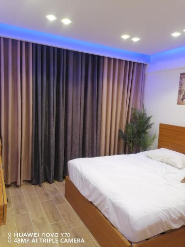 a bedroom with a bed and a large window at Bay View Resort Sahl Hashesh in Hurghada