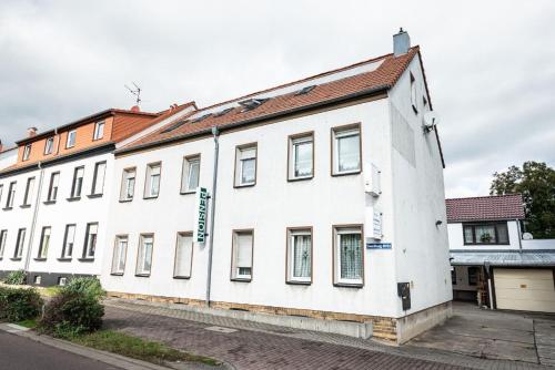 a large white building on a street at Pension Greiser in Leipzig