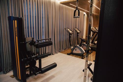 a gym with two treadmills and some exercise equipment at Nobile Grand Itapema in Itapema