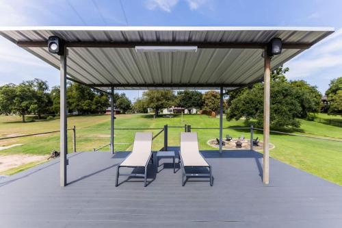 a pavilion with chairs and a picnic table in a park at Lakefront Paradise with Firepit in Meadowlakes
