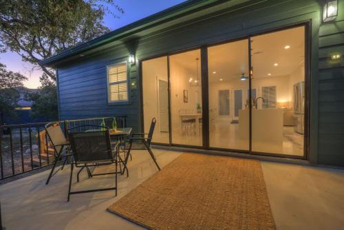 a screened in porch with a table and chairs at Serene Guadalupe River Getaway-River Access! in Cranes Mill