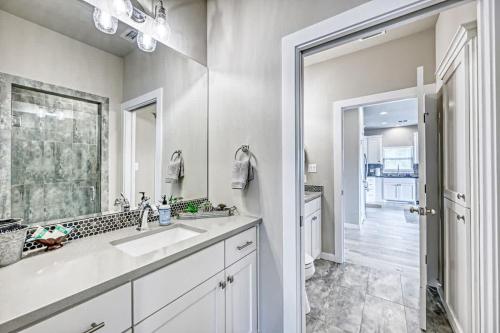 a white bathroom with a sink and a mirror at The Ricardo in Fredericksburg