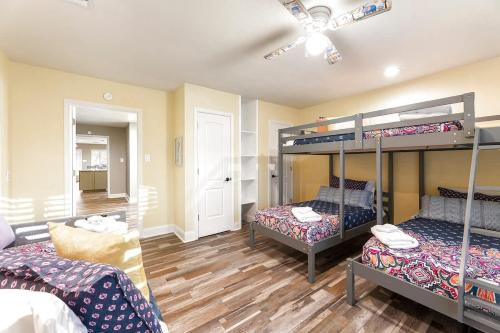 a room with two bunk beds and a ceiling fan at Luxury on Lake LBJ with Hot Tub Firepit & Boat Slip in Horseshoe Bay