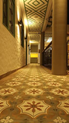 an empty hallway with a tile floor in a building at Paraíso Plaza - Hotel Boutique in Aguadas