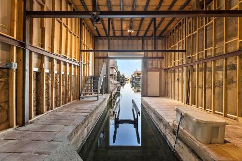a empty barn with a chair sitting in the water at Luxury on Lake LBJ with Hot Tub Firepit & Boat Slip in Horseshoe Bay